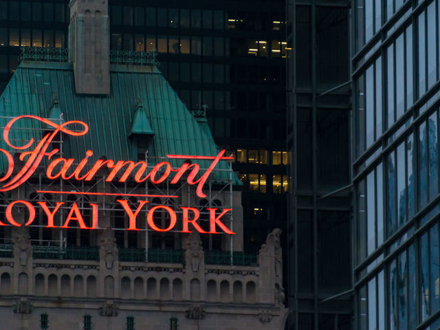 TORONTO, ONTARIO, CANADA - 2015/06/20: Fairmont Royal York sign on the roof at night. The Fairmont Royal York Hotel, formerly the Royal York Hotel and still often so called, is a large and historic hotel in downtown Toronto, Ontario, Canada, at 100 Front Street West.