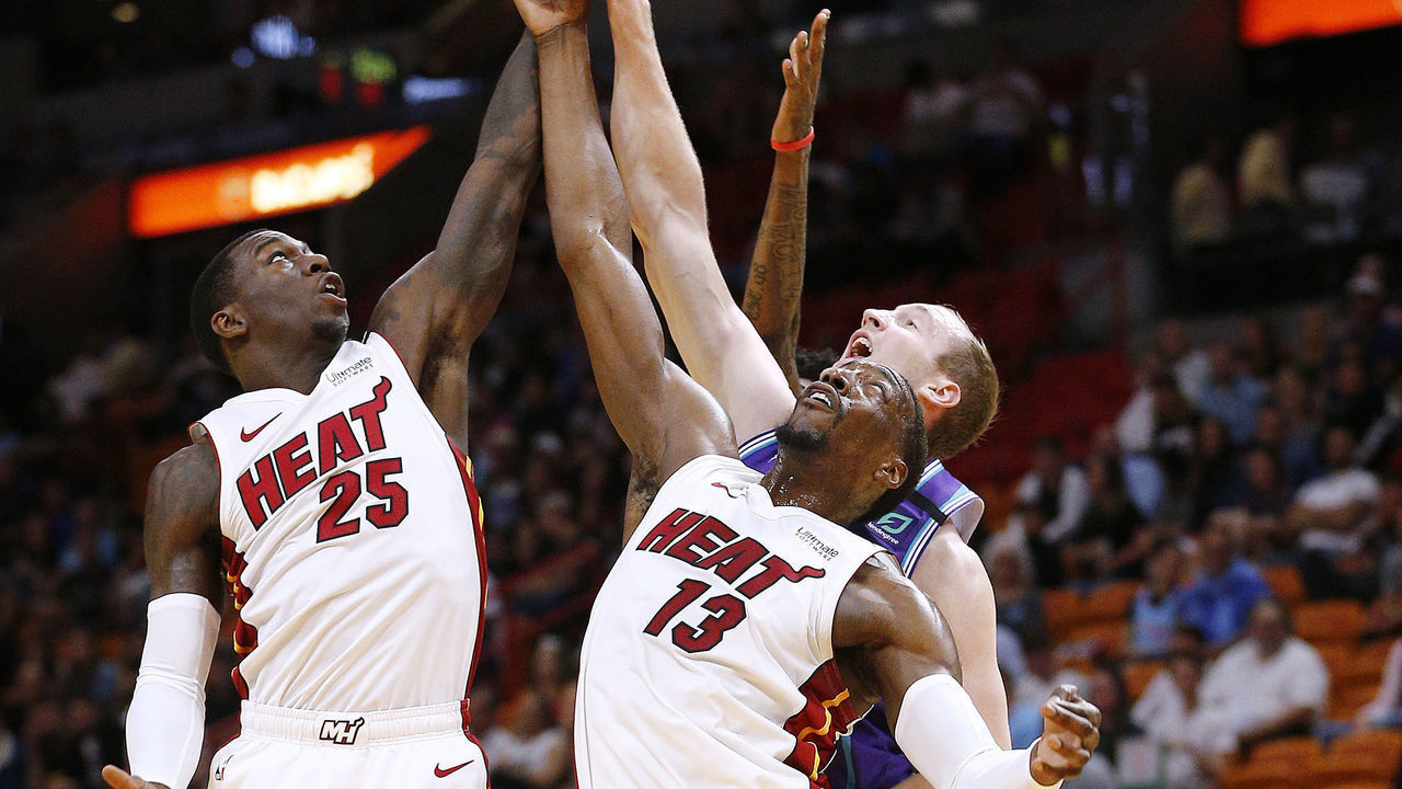 MIAMI, FLORIDA - MARCH 11: Bam Adebayo #13 and Kendrick Nunn #25 of the Miami Heat battle for a rebound with Cody Zeller #40 of the Charlotte Hornets during the first half at American Airlines Arena on March 11, 2020 in Miami, Florida. NOTE TO USER: User expressly acknowledges and agrees that, by downloading and/or using this photograph, user is consenting to the terms and conditions of the Getty Images License Agreement.