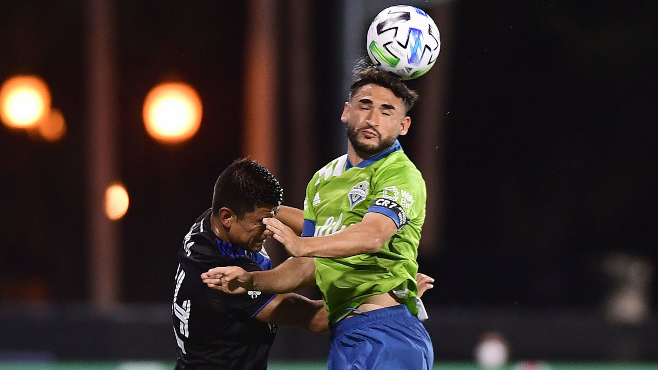 REUNION, FLORIDA - JULY 10: Trey Muse #1 of Seattle Sounders heads the ball against Jackson Yueill #14 of San Jose Earthquakes during the first half of their game at ESPN Wide World of Sports Complex on July 10, 2020 in Reunion, Florida.