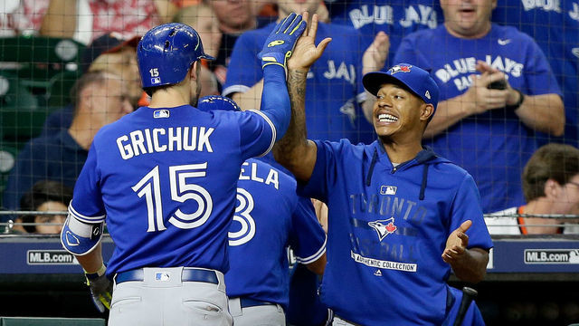 HOUSTON, TX - JUNE 25: Randal Grichuk #15 of the Toronto Blue Jays receives a high five from Marcus Stroman #6 after hitting a two-run home run against the Houston Astros in the eighth inning at Minute Maid Park on June 25, 2018 in Houston, Texas.