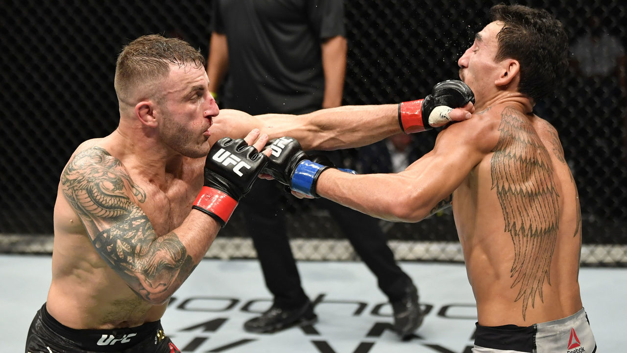 ABU DHABI, UNITED ARAB EMIRATES - JULY 12: (L-R) Alexander Volkanovski of Australia punches Max Holloway in their UFC featherweight championship fight during the UFC 251 event at Flash Forum on UFC Fight Island on July 12, 2020 on Yas Island, Abu Dhabi, United Arab Emirates.