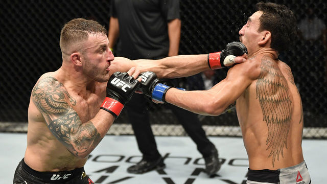 ABU DHABI, UNITED ARAB EMIRATES - JULY 12: (L-R) Alexander Volkanovski of Australia punches Max Holloway in their UFC featherweight championship fight during the UFC 251 event at Flash Forum on UFC Fight Island on July 12, 2020 on Yas Island, Abu Dhabi, United Arab Emirates.