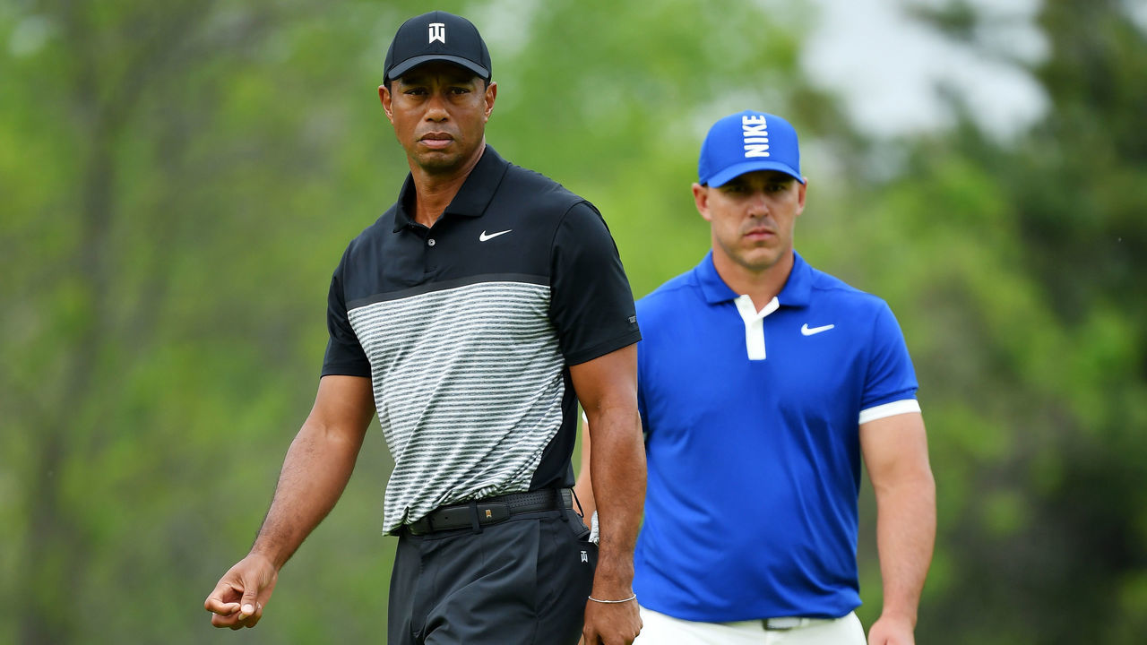 FARMINGDALE, NEW YORK - MAY 17: Tiger Woods of the United States and Brooks Koepka of the United States walk along the course during the second round of the 2019 PGA Championship at the Bethpage Black course on May 17, 2019 in Farmingdale, New York.
