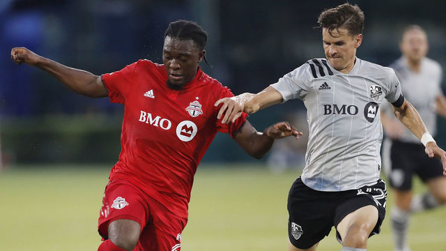 REUNION, FLORIDA - JULY 16: Ayo Akinola #20 of Toronto FC battles with Jukka Raitala #22 of Montreal Impact for control of the ball during a Group C match as part of the MLS Is Back Tournament at ESPN Wide World of Sports Complex on July 16, 2020 in Reunion, Florida.