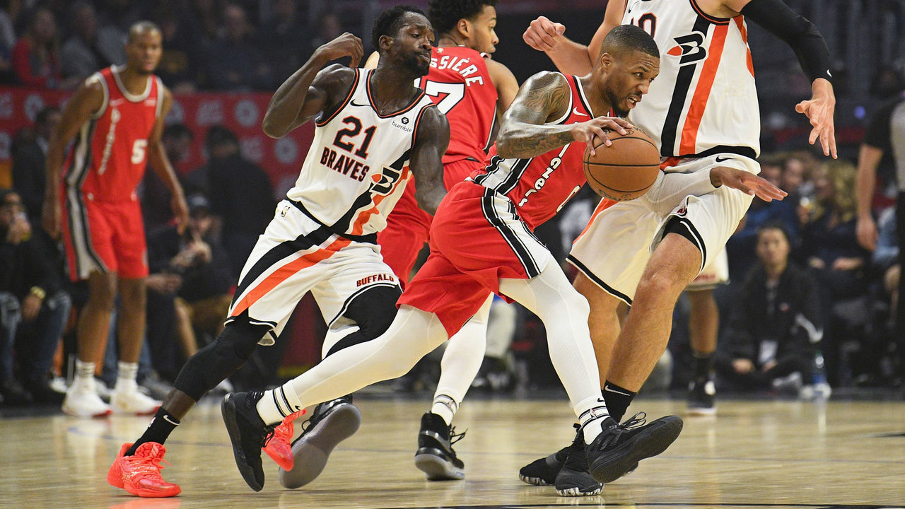 LOS ANGELES, CA - NOVEMBER 07: Portland Trail Blazers Guard Damian Lillard (0) tries to dribble past Los Angeles Clippers Guard Patrick Beverley (21) and Los Angeles Clippers Center Ivica Zubac (40) during a NBA game between the Portland Trailblazers and the Los Angeles Clippers on November 7, 2019 at STAPLES Center in Los Angeles, CA.