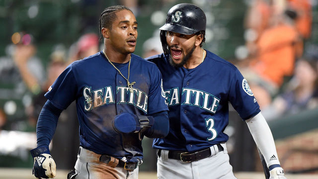 BALTIMORE, MD - SEPTEMBER 21: Mallex Smith #0 of the Seattle Mariners celebrates with J.P. Crawford #3 after scoring the game winning run in the 13th inning against the Baltimore Orioles at Oriole Park at Camden Yards on September 21, 2019 in Baltimore, Maryland.
