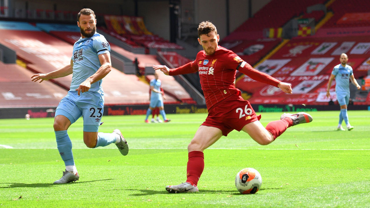 LIVERPOOL, ENGLAND - JULY 11: Erik Pieters of Burnley looks to block a shot from Andy Robertson of Liverpool during the Premier League match between Liverpool FC and Burnley FC at Anfield on July 11, 2020 in Liverpool, England. Football Stadiums around Europe remain empty due to the Coronavirus Pandemic as Government social distancing laws prohibit fans inside venues resulting in all fixtures being played behind closed doors.