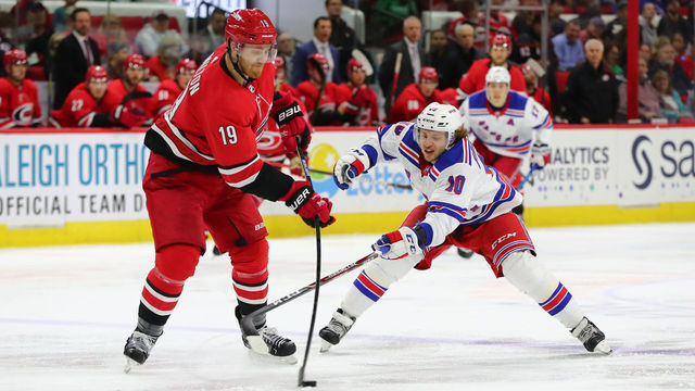 RALEIGH, NC - NOVEMBER 07: Carolina Hurricanes defenseman Dougie Hamilton (19) passes the puck while New York Rangers center Artemi Panarin (10) goes for it during the 2nd period of the Carolina Hurricanes game versus the New York Rangers on November 7th, 2019 at PNC Arena in Raleigh, NC