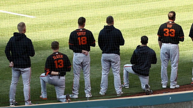 OAKLAND, CALIFORNIA - JULY 20: Austin Slater #13 and Jaylin Davis #49 of the San Francisco Giants kneel during the National Anthem before their exhibition game against the Oakland Athletics at Oakland-Alameda County Coliseum on July 20, 2020 in Oakland, California.