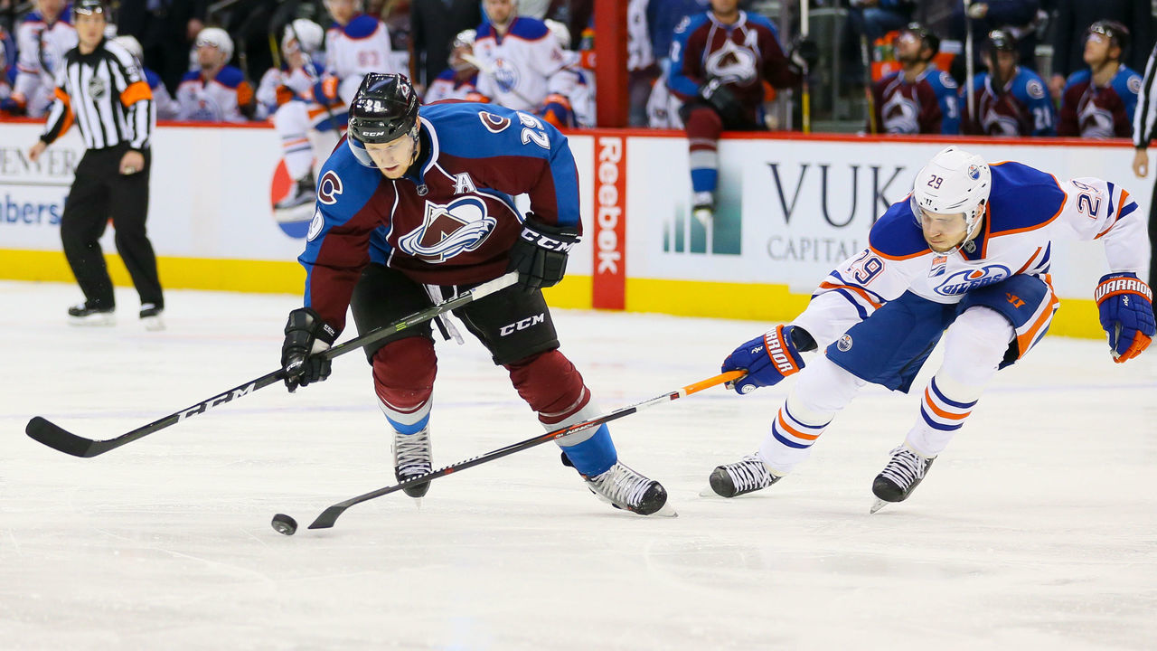 DENVER, CO - NOVEMBER 23: Leon Draisaitl #29 of the Edmonton Oilers pokes the puck away from Nathan MacKinnon #29 of the Colorado Avalanche during a power play in the second period at Pepsi Center on November 23, 2016 in Denver, Colorado.