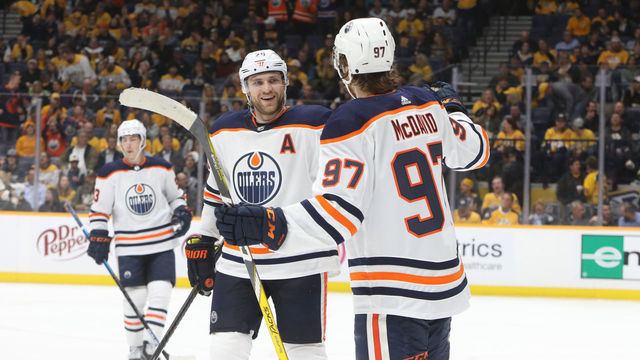 NASHVILLE, TN - MARCH 02: Edmonton Oilers center Connor McDavid (97) celebrates a third period goal by center Leon Draisaitl (29) during the NHL game between the Nashville Predators and Edmonton Oilers, held on March 2, 2020, at Bridgestone Arena in Nashville, Tennessee.