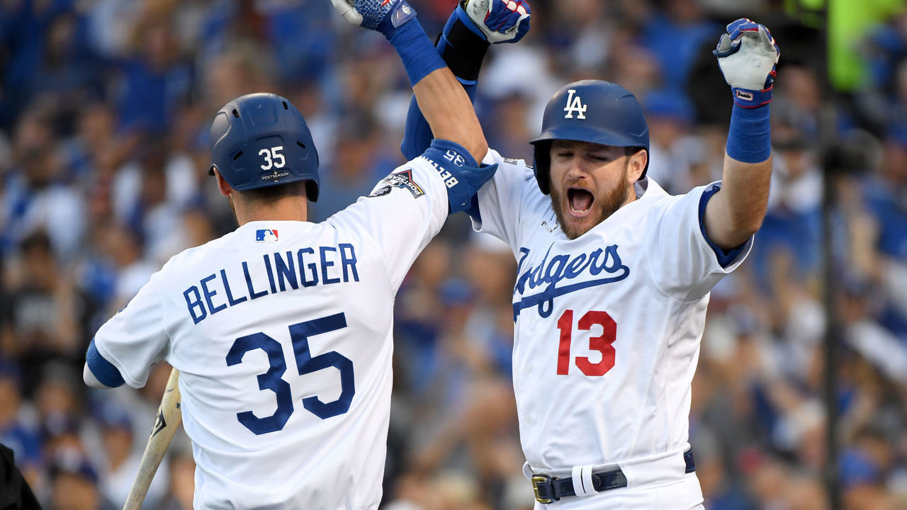 LOS ANGELES, CALIFORNIA - OCTOBER 09: Max Muncy #13 of the Los Angeles Dodgers celebrates his two run home run with teammate Cody Bellinger #35 during the first inning of game five of the National League Division Series against the Washington Nationals at Dodger Stadium on October 09, 2019 in Los Angeles, California.