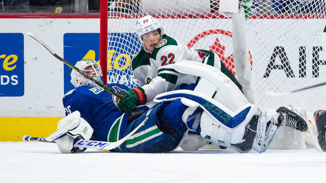 VANCOUVER, BC - FEBRUARY 19: Minnesota Wild Right Wing Kevin Fiala (22) and Vancouver Canucks Goaltender Jacob Markstrom (25) lays on the ice during their NHL game at Rogers Arena on February 19, 2020 in Vancouver, British Columbia, Canada.