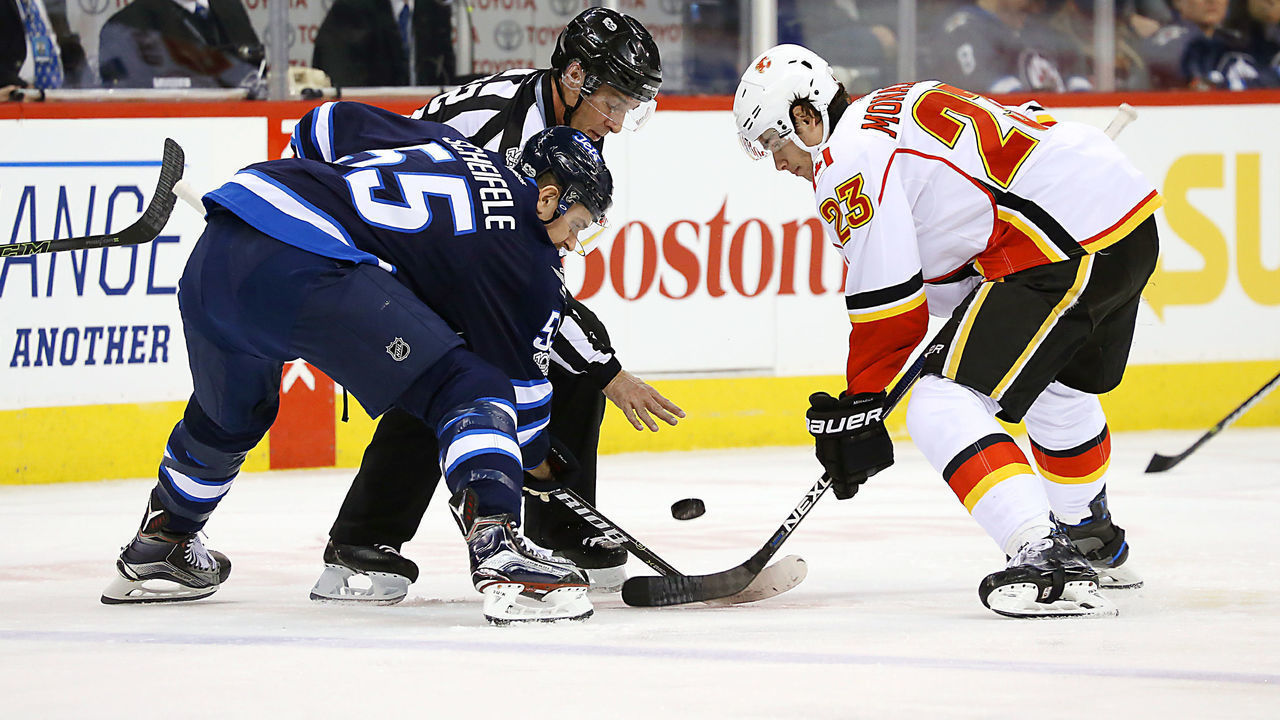 WINNIPEG, MB - MARCH 11: Mark Scheifele #55 of the Winnipeg Jets takes a first period face-off against Sean Monahan #23 of the Calgary Flames at the MTS Centre on March 11, 2017 in Winnipeg, Manitoba, Canada.