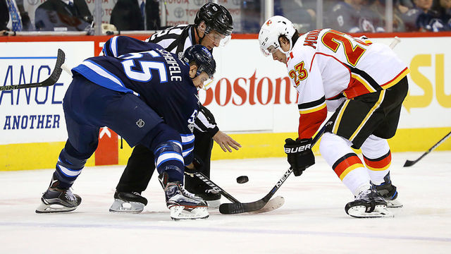 WINNIPEG, MB - MARCH 11: Mark Scheifele #55 of the Winnipeg Jets takes a first period face-off against Sean Monahan #23 of the Calgary Flames at the MTS Centre on March 11, 2017 in Winnipeg, Manitoba, Canada.