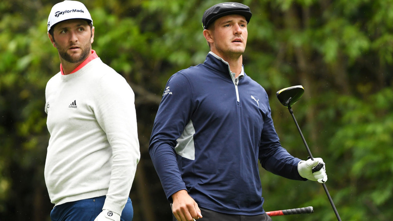 PACIFIC PALISADES, CALIFORNIA - FEBRUARY 15: Jon Rahm of Spain (L) and Bryson DeChambeau watch a tee shot on the 12th hole during the second round of the Genesis Open at Riviera Country Club on February 15, 2019 in Pacific Palisades, California.