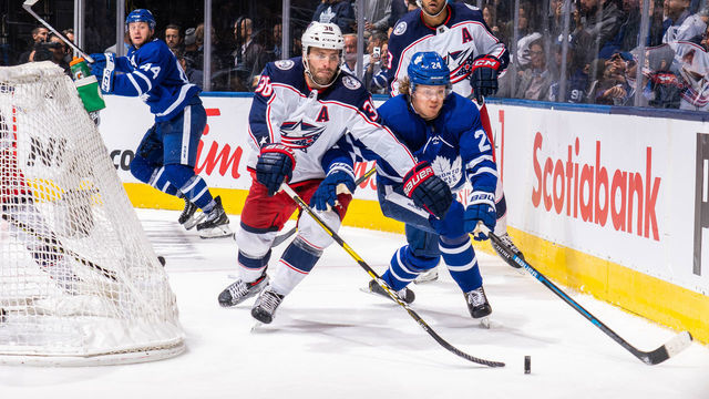 TORONTO, ON - OCTOBER 21: Boone Jenner #38 of the Columbus Blue Jackets battles for the puck with Kasperi Kapanen #24 of the Toronto Maple Leafs during the third period at the Scotiabank Arena on October 21, 2019 in Toronto, Ontario, Canada.