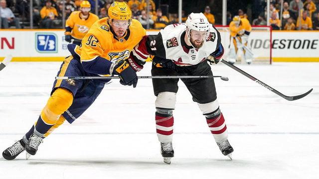 NASHVILLE, TN - DECEMBER 14: Ryan Johansen #92 of the Nashville Predators skates against Derek Stepan #21 of the Arizona Coyotes at Bridgestone Arena on December 14, 2019 in Nashville, Tennessee.