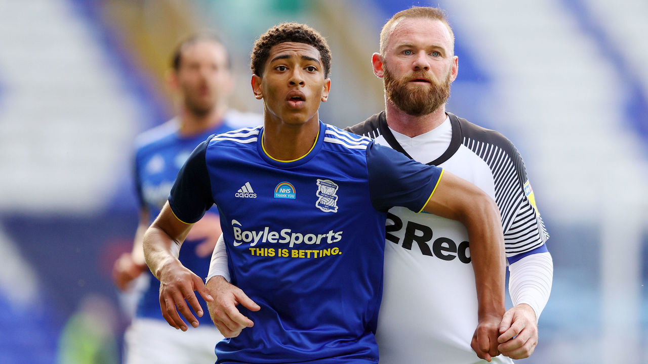 BIRMINGHAM, ENGLAND - JULY 22: Jude Bellingham of Birmingham City and Wayne Rooney of Derby County during the Sky Bet Championship match between Birmingham City and Derby County at St Andrew's Trillion Trophy Stadium on July 22, 2020 in Birmingham, England. Football Stadiums around Europe remain empty due to the Coronavirus Pandemic as Government social distancing laws prohibit fans inside venues resulting in all fixtures being played behind closed doors.