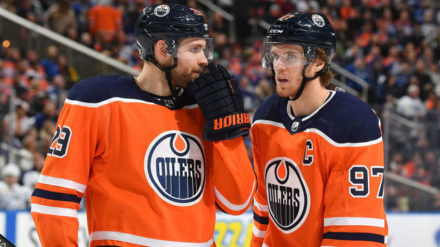 EDMONTON, AB - DECEMBER 14: Leon Draisaitl #29 and Connor McDavid #97 of the Edmonton Oilers discuss the play during the game against the Toronto Maple Leafs on December 14, 2019, at Rogers Place in Edmonton, Alberta, Canada.