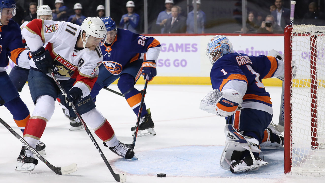 NEW YORK, NEW YORK - NOVEMBER 09: Jonathan Huberdeau #11 of the Florida Panthers shoots against Thomas Greiss #1 of the New York Islanders in the first period during their game at Barclays Center on November 09, 2019 in New York City.