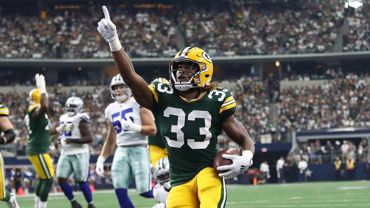 ARLINGTON, TEXAS - OCTOBER 06: Aaron Jones #33 of the Green Bay Packers celebrates after scoring on an 18-yard run against the Dallas Cowboys in the first quarter of their game at AT&T Stadium on October 06, 2019 in Arlington, Texas.