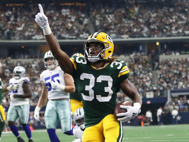 ARLINGTON, TEXAS - OCTOBER 06: Aaron Jones #33 of the Green Bay Packers celebrates after scoring on an 18-yard run against the Dallas Cowboys in the first quarter of their game at AT&T Stadium on October 06, 2019 in Arlington, Texas.