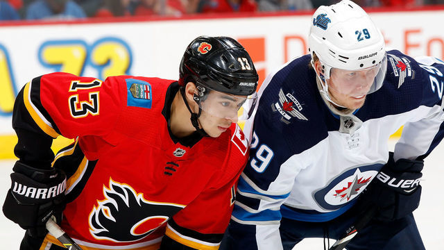 CALGARY, AB - NOVEMBER 21: Calgary Flames Left Wing Johnny Gaudreau #13 and Winnipeg Jets Right Wing Patrik Laine #29 skate during an NHL game on November 21, 2018 at the Scotiabank Saddledome in Calgary, Alberta, Canada.