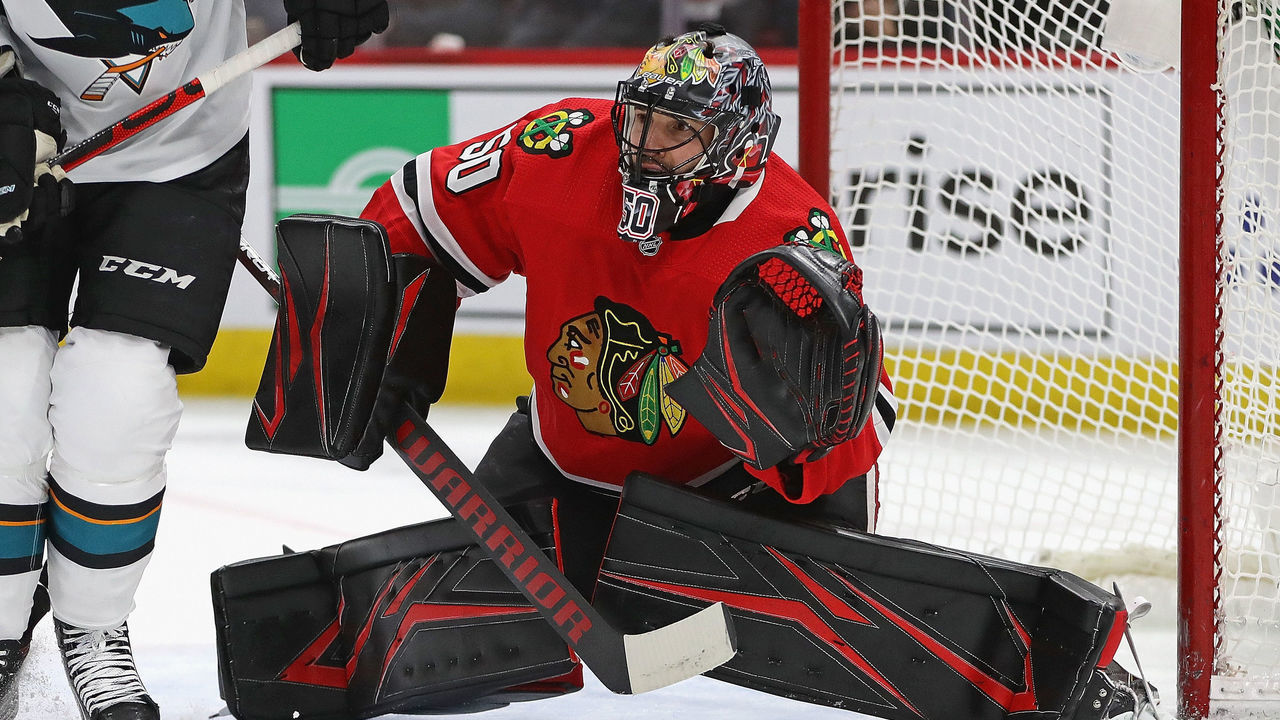 CHICAGO, ILLINOIS - MARCH 11: Corey Crawford #50 of the Chicago Blackhawks minds the net against the San Jose Sharks at the United Center on March 11, 2020 in Chicago, Illinois.