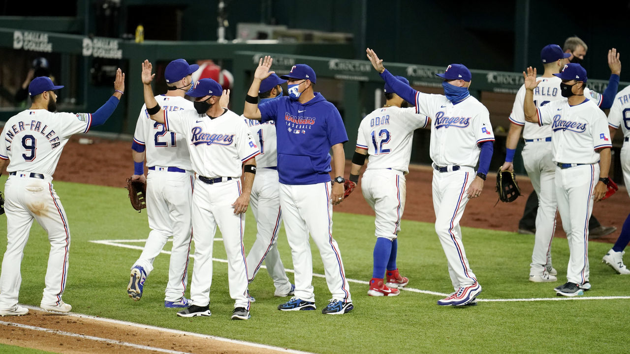 ARLINGTON, TX - JULY 24: Members of the Texas Rangers celebrate after the Rangers defeated the Colorado Rockies at Globe Life Field in Arlington on Friday, July 24, 2020 in Arlington, Texas.