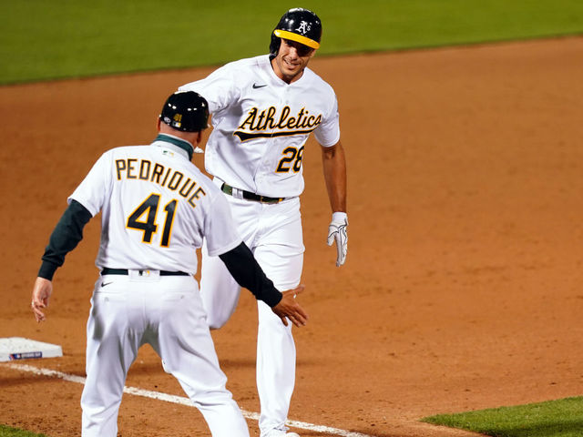 OAKLAND, CA - JULY 24: Matt Olson #28 of the Oakland Athletics celebrates with third base coach Al Pedrique after hitting a walk-off grand slam to win the game between the Los Angeles Angels and the Oakland Athletics at Oakland Coliseum on Friday, July 24, 2020 in Oakland, California.