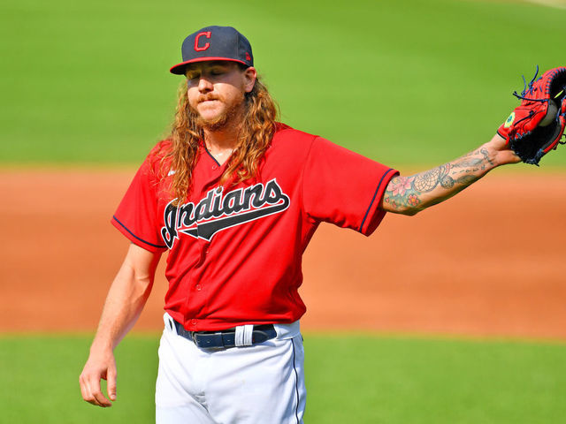 CLEVELAND, OHIO - JULY 25: Starting pitcher Mike Clevinger #52 of the Cleveland Indians reacts after giving up a solo homer to Salvador Perez #13 of the Kansas City Royals during the first inning at Progressive Field on July 25, 2020 in Cleveland, Ohio. The 2020 season had been postponed since March due to the COVID-19 pandemic.