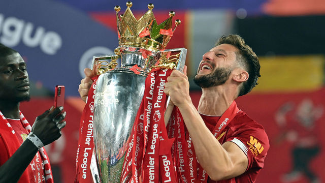 Liverpool's Adam Lallana lifts the Premier League Trophy at Anfield.