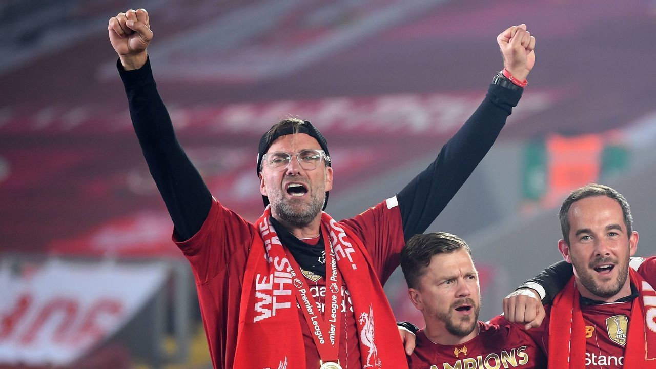 Liverpool's German manager Jurgen Klopp celebrates during the Premier League trophy presentation following the English Premier League football match between Liverpool and Chelsea at Anfield in Liverpool, north west England on July 22, 2020. - Liverpool on Wednesday lifted the Premier League trophy at the famous Kop stand at Anfield after their final home game of the season. With no fans able to attend due to the COVID-19 coronavirus pandemic, Liverpool said the idea for the trophy lift was to honour the club's fans, but Liverpool manager Jurgen Klopp urged fans to respect social distancing measures, after thousands gathered around the club's stadium and in the city centre following their coronation as champions last month.