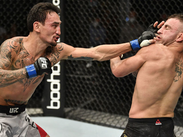 ABU DHABI, UNITED ARAB EMIRATES - JULY 12: (L-R) Max Holloway punches Alexander Volkanovski of Australia in their UFC featherweight championship fight during the UFC 251 event at Flash Forum on UFC Fight Island on July 12, 2020 on Yas Island, Abu Dhabi, United Arab Emirates.