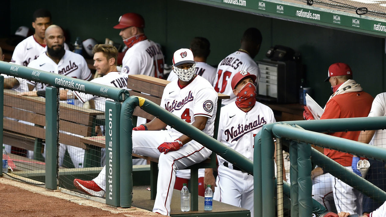 WASHINGTON, DC - JULY 21: Washington Nationals manager David Dave Martinez (4) wears a face mask in the dugout during the MLB Summer Camp scrimmage between the Baltimore Orioles and Washington Nationals at Nationals Park on July 21, 2020 in Washington, D.C..