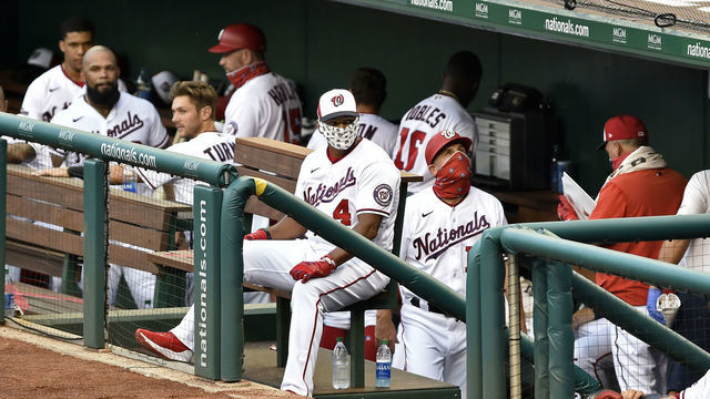 WASHINGTON, DC - JULY 21: Washington Nationals manager David Dave Martinez (4) wears a face mask in the dugout during the MLB Summer Camp scrimmage between the Baltimore Orioles and Washington Nationals at Nationals Park on July 21, 2020 in Washington, D.C..