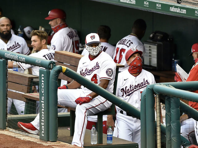 WASHINGTON, DC - JULY 21: Washington Nationals manager David Dave Martinez (4) wears a face mask in the dugout during the MLB Summer Camp scrimmage between the Baltimore Orioles and Washington Nationals at Nationals Park on July 21, 2020 in Washington, D.C..