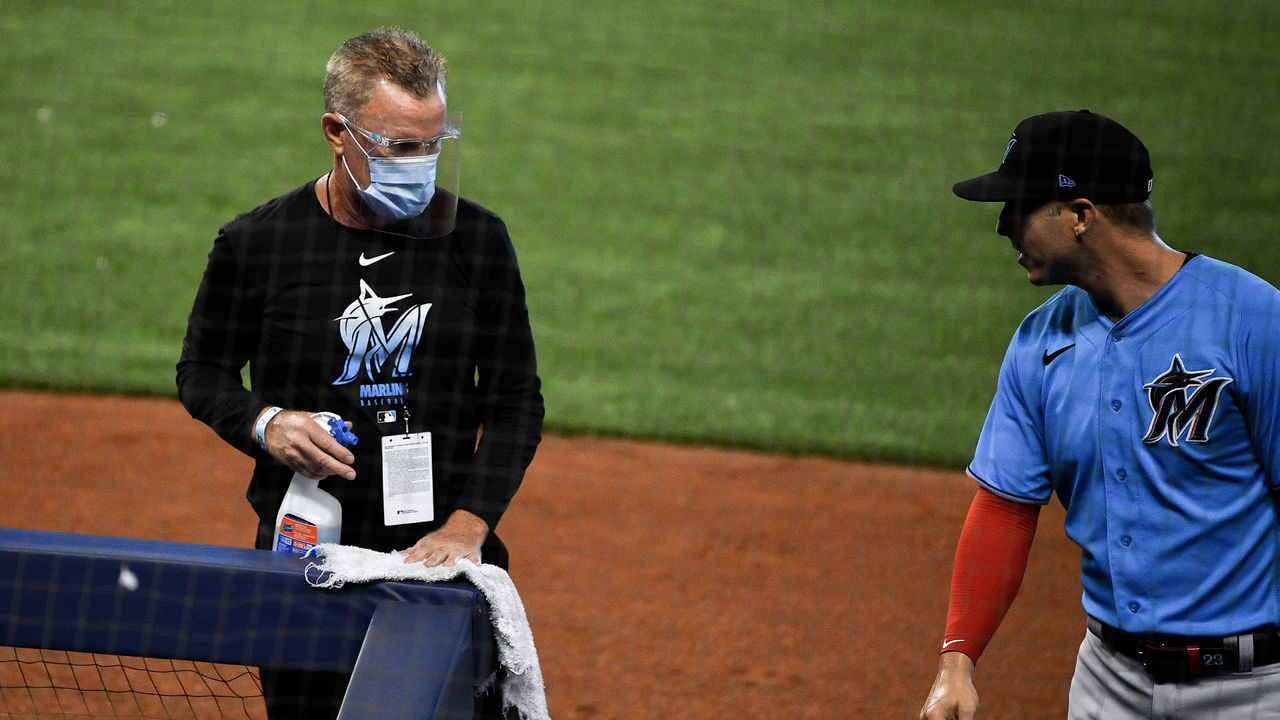MIAMI, FLORIDA - JULY 09: Miami Marlins training staff sanitizes the bench area in between innings during an intrasquad simulated game at Marlins Park on July 09, 2020 in Miami, Florida.