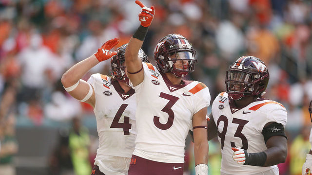 MIAMI, FLORIDA - OCTOBER 05: Caleb Farley #3 of the Virginia Tech Hokies celebrates with teammates against the Miami Hurricanes during the first half at Hard Rock Stadium on October 05, 2019 in Miami, Florida.