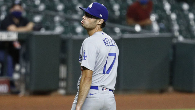 HOUSTON, TEXAS - JULY 28: Joe Kelly #17 of the Los Angeles Dodgers looks back at Carlos Correa #1 of the Houston Astros in the sixth inning as they exchange words after he knocked down Correa with a high pitch at Minute Maid Park on July 28, 2020 in Houston, Texas.