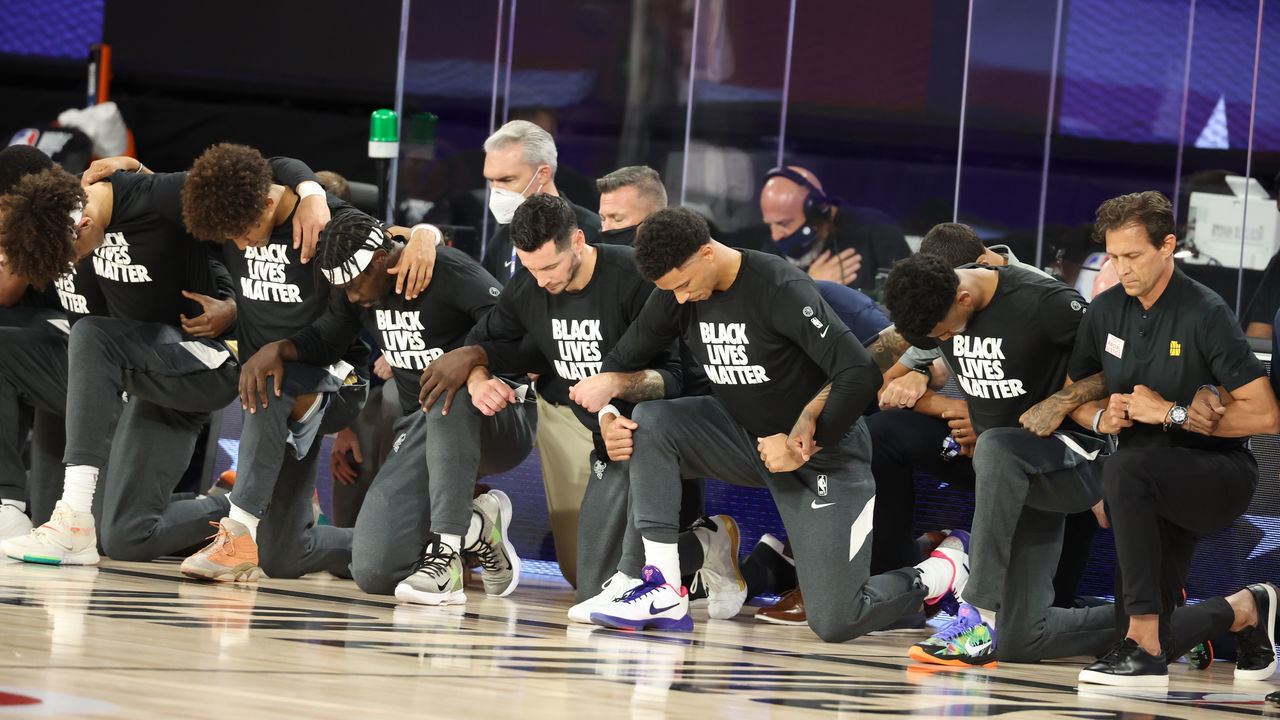 Orlando, FL - JULY 30: The New Orleans Pelicans and the Utah Jazz kneel for the National Anthem prior to a game on July 30, 2020 at HP Field House at ESPN Wide World of Sports in Orlando, Florida. NOTE TO USER: User expressly acknowledges and agrees that, by downloading and/or using this Photograph, user is consenting to the terms and conditions of the Getty Images License Agreement. Mandatory Copyright Notice: Copyright 2020 NBAE
