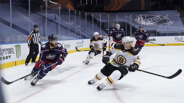 TORONTO, ONTARIO - JULY 30: David Savard #58 of the Columbus Blue Jackets and Brad Marchand #63 of the Boston Bruins turns to skate up ice during the second period of an exhibition game prior to the 2020 NHL Stanley Cup Playoffs at Scotiabank Arena on July 30, 2020 in Toronto, Ontario.