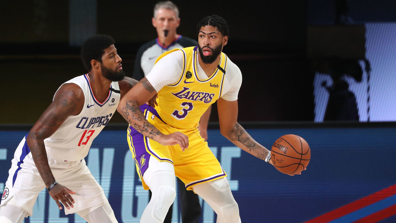 Orlando, FL - JULY 30: Anthony Davis #3 of the Los Angeles Lakers handles the ball while Paul George #13 of the LA Clippers plays defense during a game on July 30, 2020 at The Arena at ESPN Wide World Of Sports Complex in Orlando, Florida. NOTE TO USER: User expressly acknowledges and agrees that, by downloading and/or using this Photograph, user is consenting to the terms and conditions of the Getty Images License Agreement. Mandatory Copyright Notice: Copyright 2020 NBAE