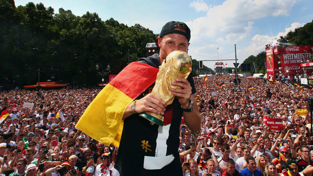 BERLIN, GERMANY - JULY 15: Benedikt Hoewedes celebrates on stage at the German team victory ceremony on July 15, 2014 in Berlin, Germany. Germany won the 2014 FIFA World Cup Brazil match against Argentina in Rio de Janeiro on July 13.