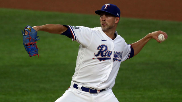 ARLINGTON, TEXAS - JULY 25: Mike Minor #23 of the Texas Rangers throws against the Colorado Rockies in the first inning at Globe Life Field on July 25, 2020 in Arlington, Texas. The 2020 season had been postponed since March due to the COVID-19 pandemic.