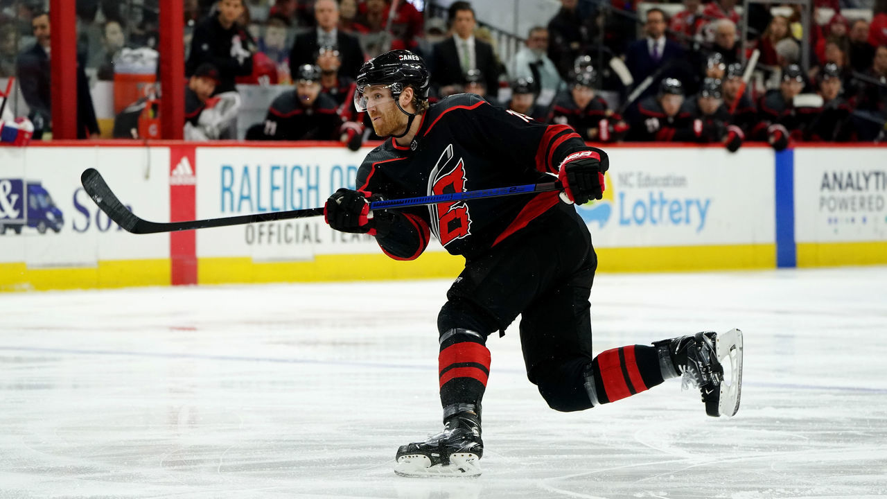 RALEIGH, NC - DECEMBER 31: Dougie Hamilton #19 of the Carolina Hurricanes shoots the puck during an NHL game against the Montreal Canadiens on December 31, 2019 at PNC Arena in Raleigh, North Carolina.