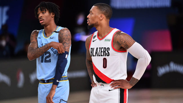 Orlando, FL - JULY 31: Ja Morant #12 of the Memphis Grizzlies and Damian Lillard #0 of the Portland Trail Blazers look on during a game on July 31, 2020 at The Arena at ESPN Wide World Of Sports Complex in Orlando, Florida. NOTE TO USER: User expressly acknowledges and agrees that, by downloading and/or using this Photograph, user is consenting to the terms and conditions of the Getty Images License Agreement. Mandatory Copyright Notice: Copyright 2020 NBAE