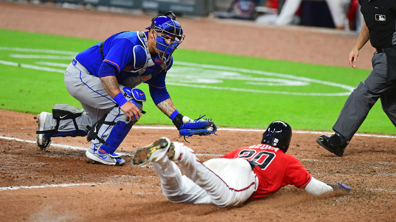 ATLANTA, GA. - JULY 31: Marcell Ozuna #20 of the Atlanta Braves slides home safely in the eighth inning against Wilson Ramos #40 of the New York Mets at SunTrust Field on June 31, 2020 in Atlanta, Georgia.