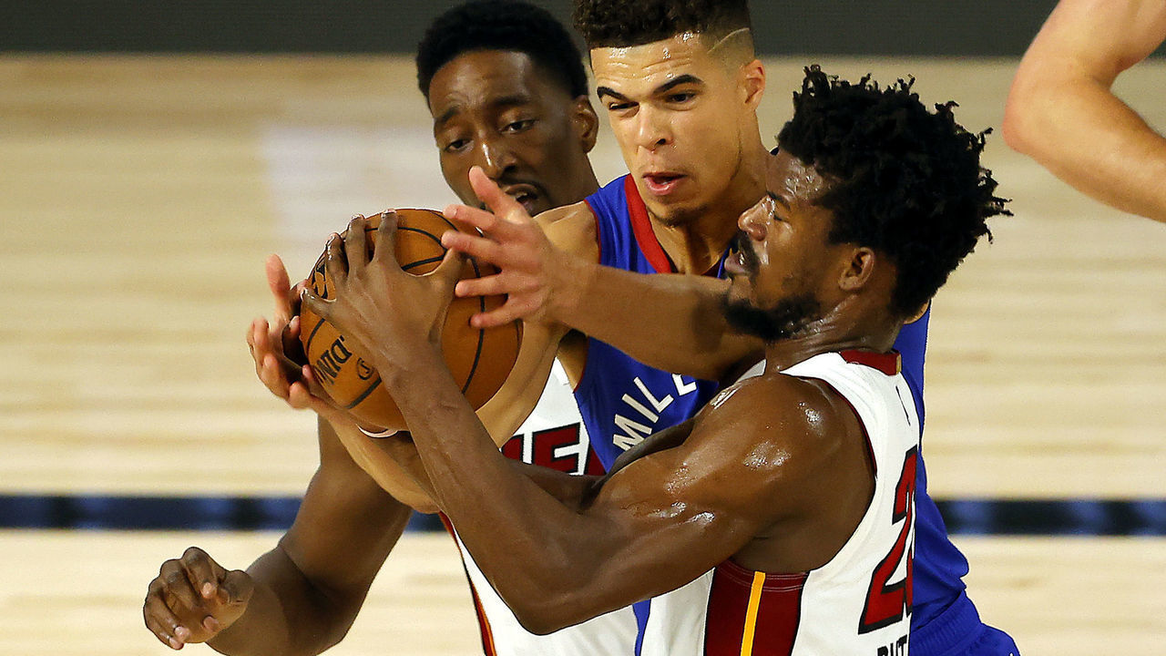 LAKE BUENA VISTA, FLORIDA - AUGUST 01: Jimmy Butler #22 of the Miami Heat is fouled by Michael Porter Jr. #1 of the Denver Nuggets as Bam Adebayo #13 of the Miami Heat looks on at HP Field House at ESPN Wide World Of Sports Complex on August 01, 2020 in Lake Buena Vista, Florida.